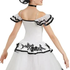 White tutu with black embellishments and large hair accessory