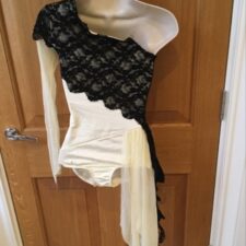 Cream one sleeve leotard with black lace crossover and net bustle