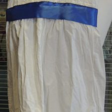 White cotton dress with blue sash and ruffle hem