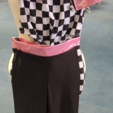Black and white checkerboard leotard, metallic pink vest and matching trousers