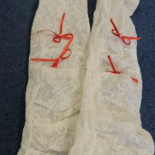 White lace gloves with red ribbon