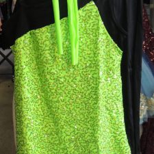 Neon green sequin A-line top and black cropped trousers