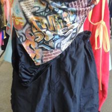 Black hip hop trousers and crop top and graffiti print sheer over top