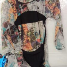 Sheer graffiti print and black long sleeve crop top and trousers