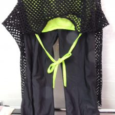 Neon green crop top with black mesh overtop and lycra flared trousers