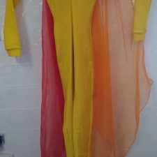 Yellow catsuit with red and orange scarves