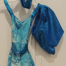 Turquoise and blue top with handkerchief hem and swirl pattern and metallic shorts