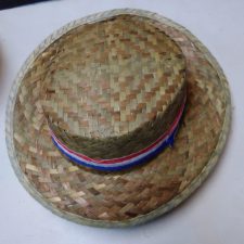 Straw hat with red, white and blue ribbon