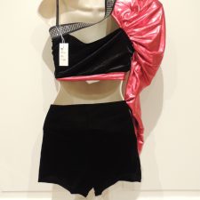 Black velvet bike shorts and red satin single sleeve crop top with sparkle trim