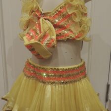 Yellow and orange crop top and skirt with ruffles