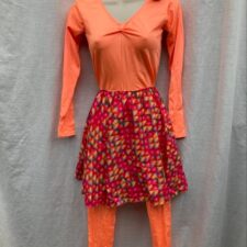 Bright orange catsuit with pink print skirt