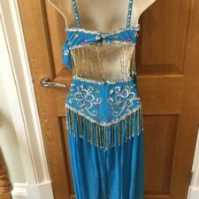 Blue harem trousers and beaded crop top, with headscarf