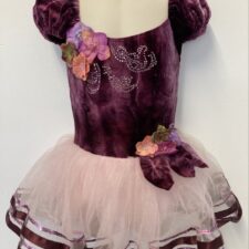 Purple velvet skirted leotard with puff sleeves and floral detail