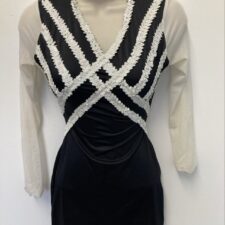 Black and white biketard with white mesh sleeves and crosshatch design