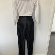 All-in-one with silver pinstriped trousers and white ruffled top