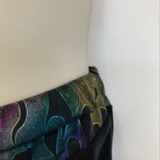 Black shorts with metallic flame design at waist