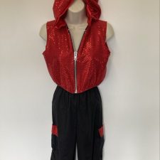Red sparkle hooded sleeveless jacket and black trousers
