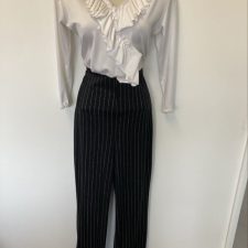 All-in-one with silver pinstriped trousers and white ruffled top