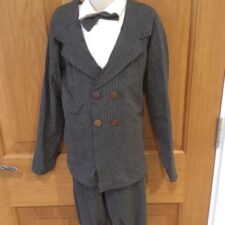 Grey pinstripe jacket, cropped trousers and leotard with bow tie