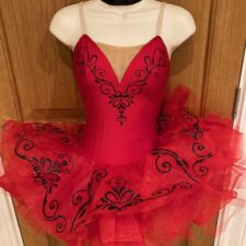Red Spanish style tutu with black sparkle design, choker, sleeve ruffles and hair flower included